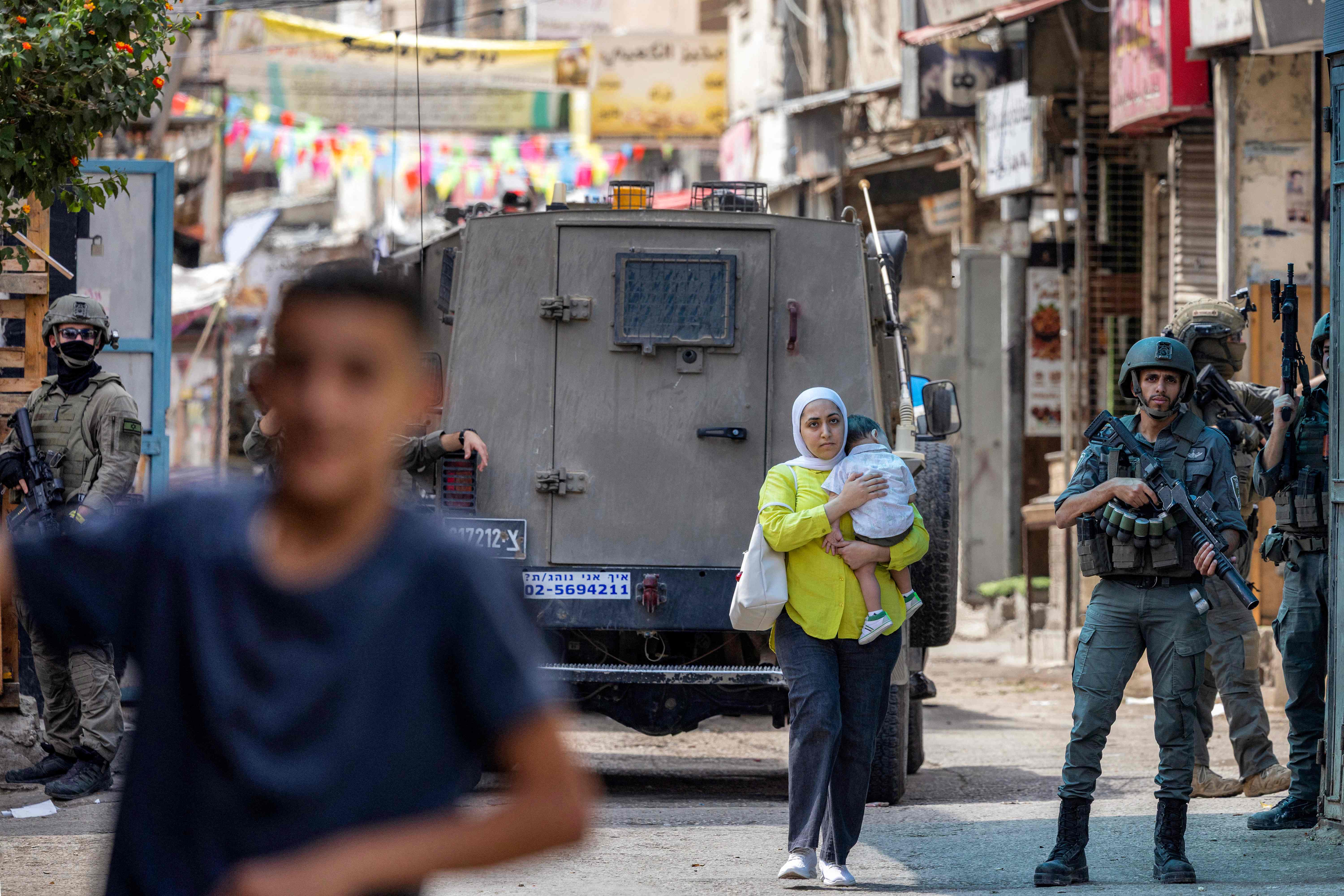 How would transferring law enforcement over Israeli settlers to police deepen de facto annexation of the West Bank?