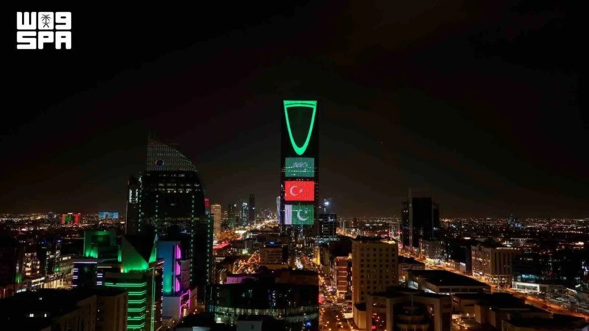 Saudi landmarks glow with three flags