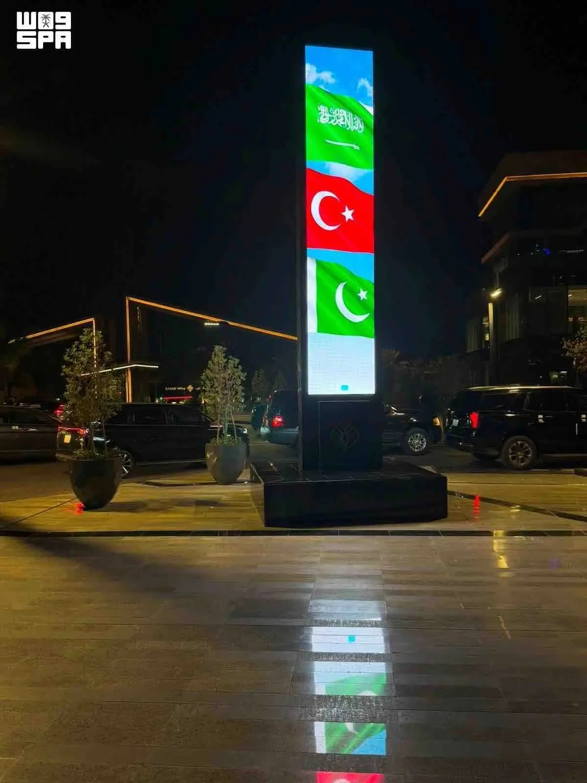 Saudi landmarks glow with three flags