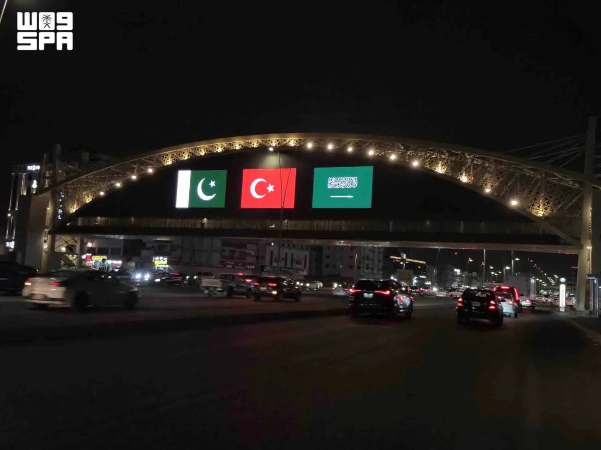 Saudi landmarks glow with three flags