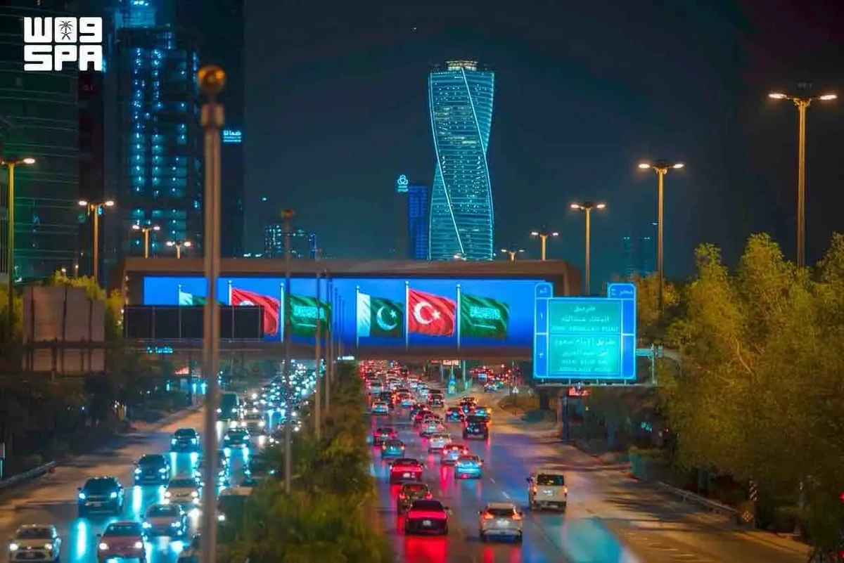 Saudi landmarks glow with three flags