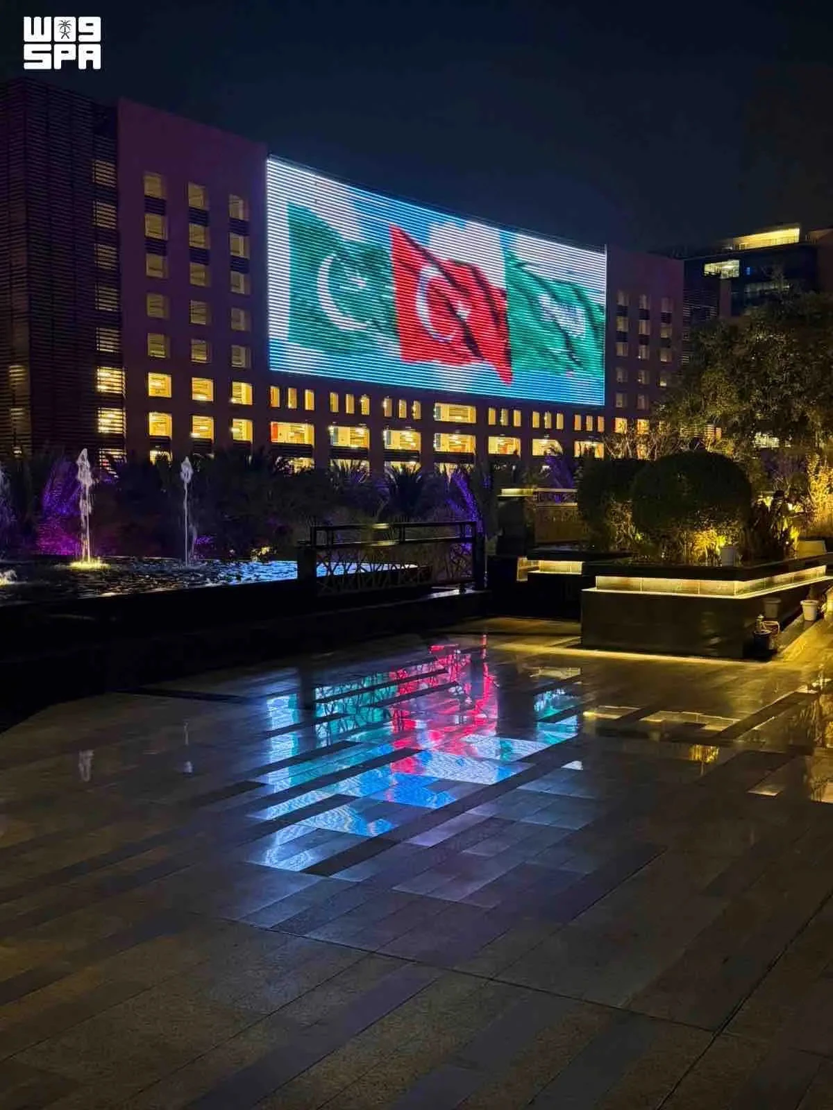 Saudi landmarks glow with three flags