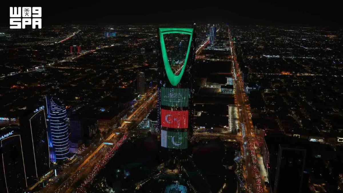 Saudi landmarks glow with three flags