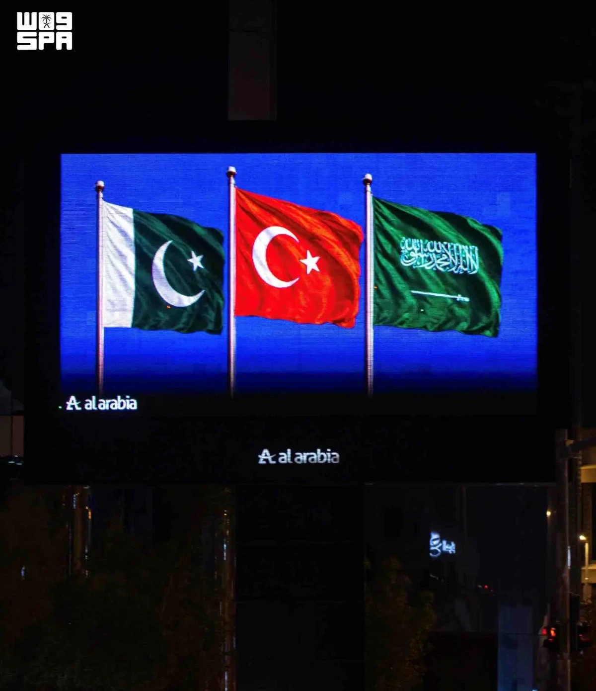 Saudi landmarks glow with three flags