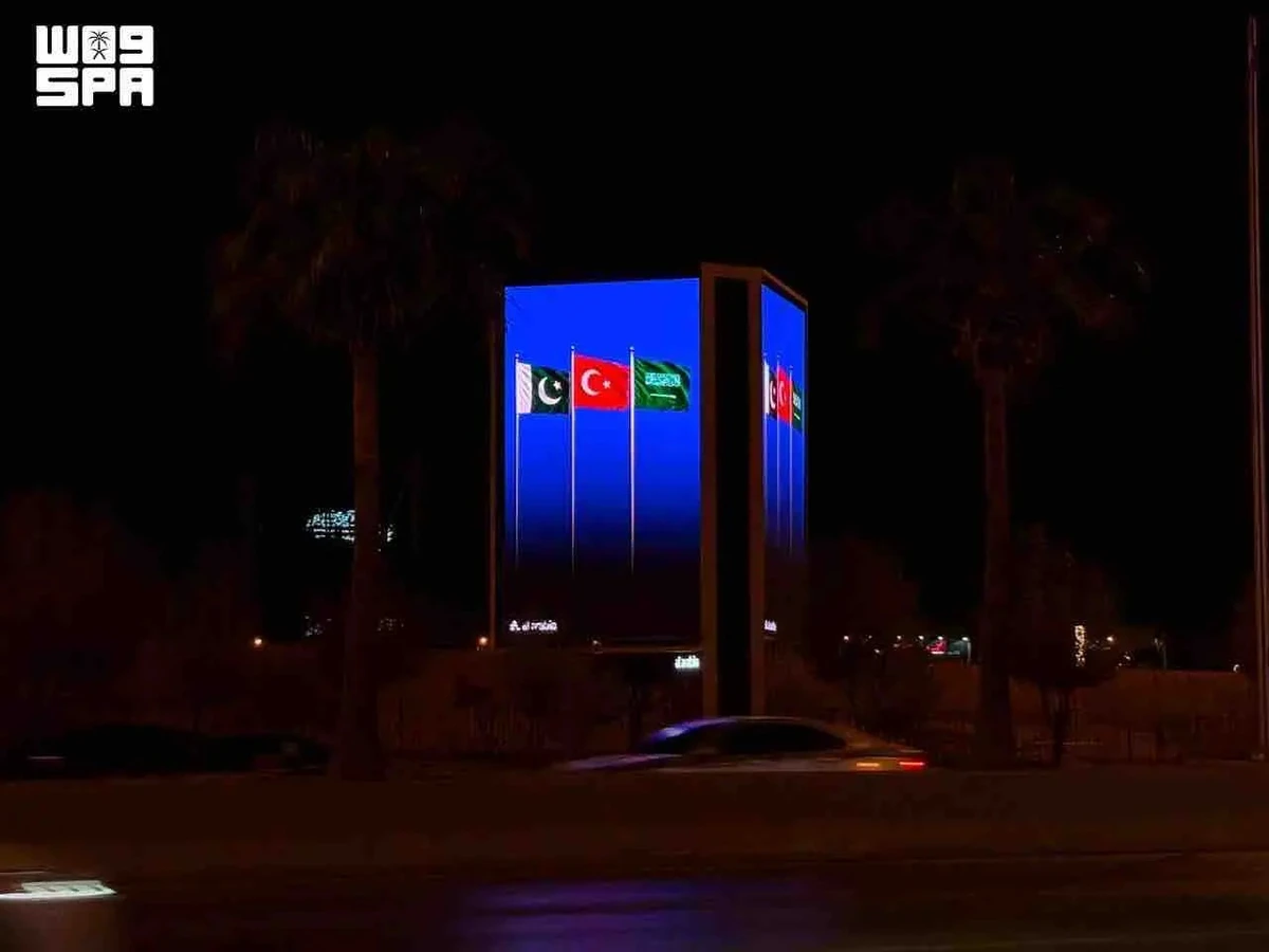 Saudi landmarks glow with three flags