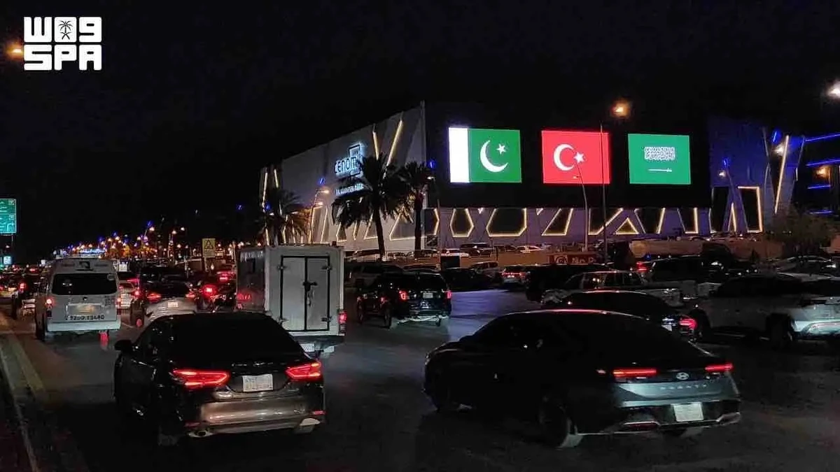 Saudi landmarks glow with three flags