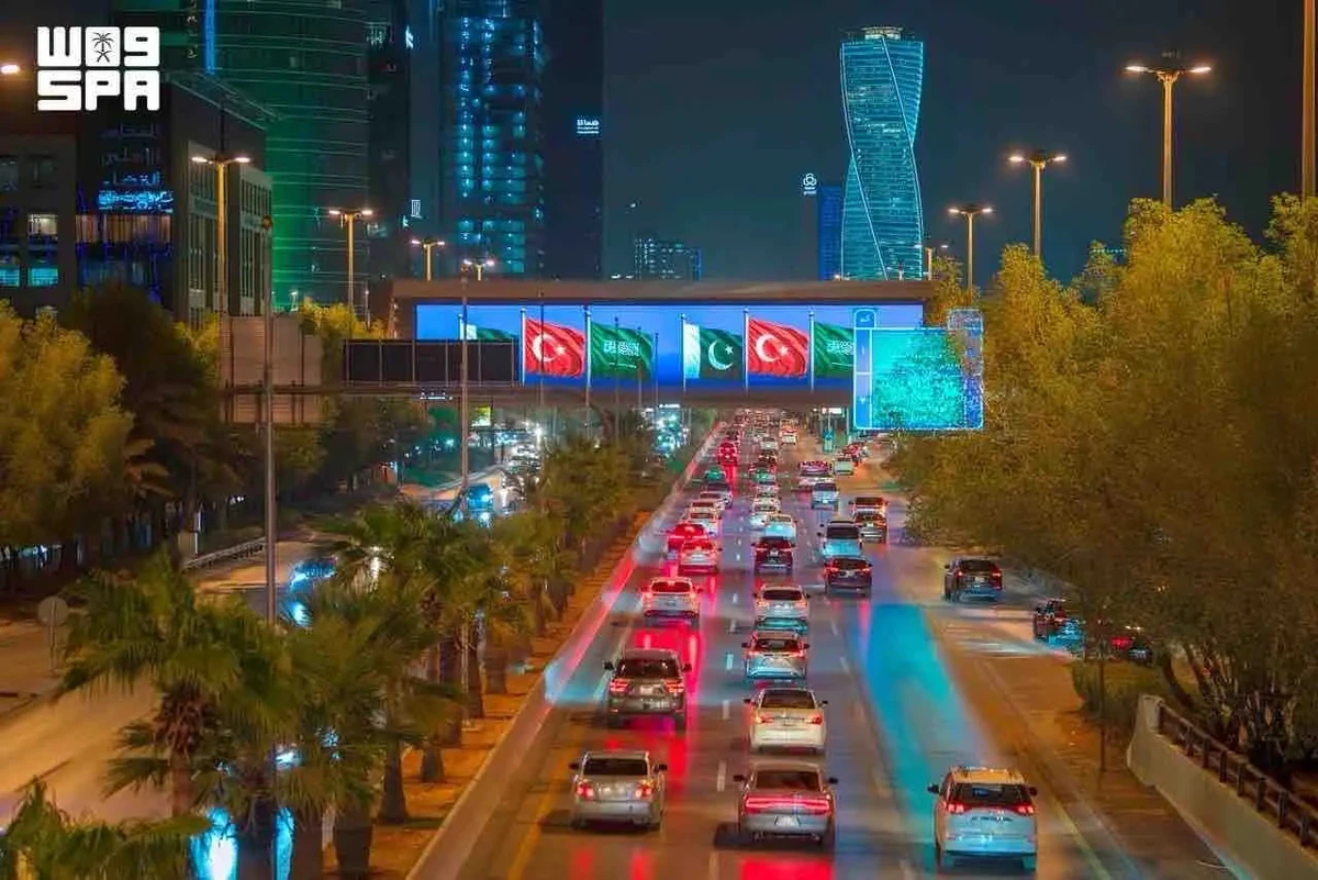 Saudi landmarks glow with three flags