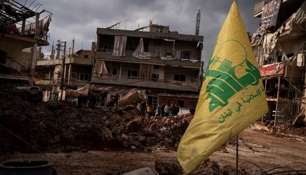 A Hezbollah flag is seen in front of destroyed buildings after an airstrike in Nabi Chit, Lebanon, Mar. 7, 2026. (Getty Images)