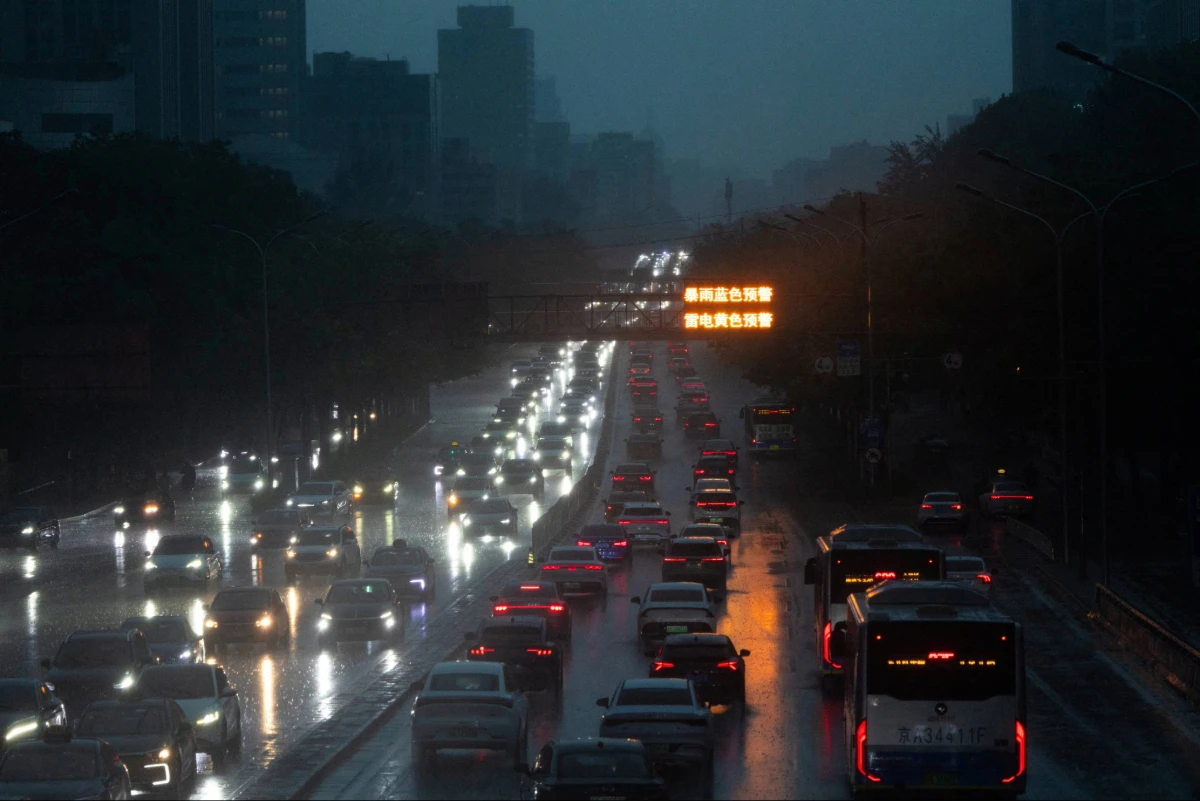 Cars drive along a street during heavy rain in Beijing, China, August 7, 2026. (Reuters)