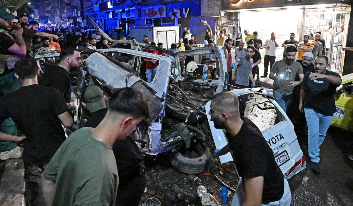 Rescuers and onlookers inspect the wreckage of a minibus at the site of a blast near Damascus August 6, 2026. (AFP)