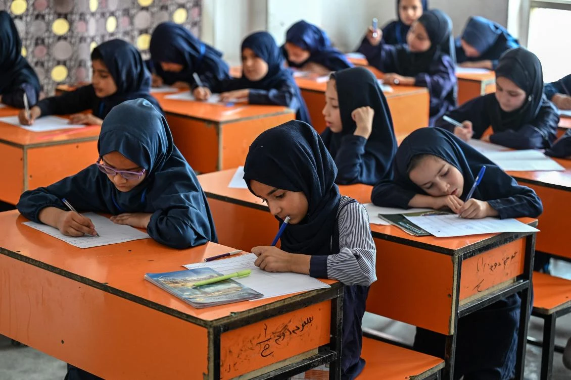 This photograph taken on July 21, 2026 shows Afghan girls taking their midterm exams at a primary school in Kabul. (File/AFP)