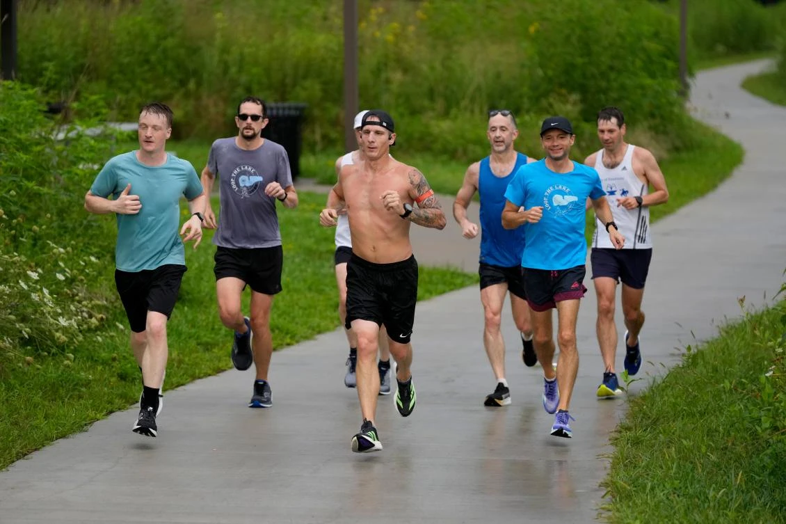 Members of the Raccoon River Running Club train on a trail at Raccoon River Park, Aug. 9, 2026, in West Des Moines, Iowa. (AP)
