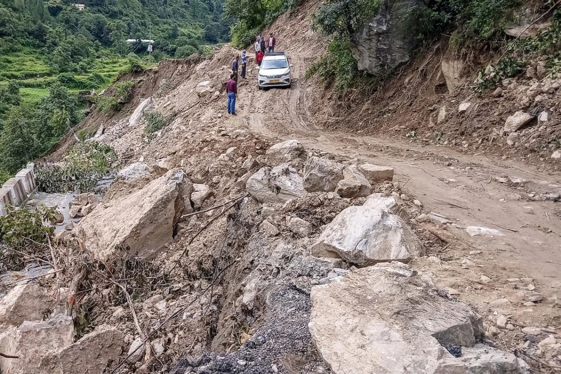 Accidents on large construction sites are common in India, but ecologists say excessive development projects have led to more disasters in the fragile Himalayan areas including Uttarakhand. Above, a car moves along a washed-out road laden with rocks and debris at Bhatwari village in Uttarakhand state on Aug. 8, 2025. (AFP file photo)