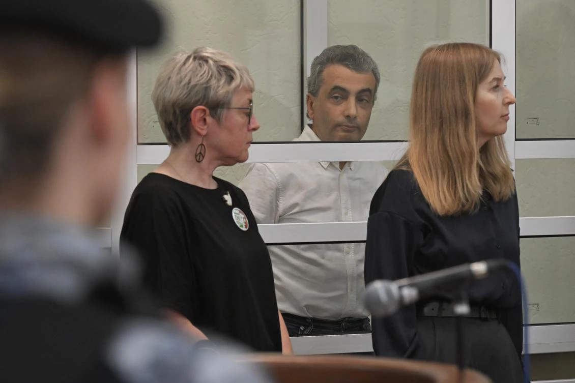 Lev Shlosberg, second right, senior member of the Yabloko party, stands in the defendant's box as the judge delivers a verdict in the case against him in a court in Pskov, Russia, Monday, Aug. 17, 2026. (AP)