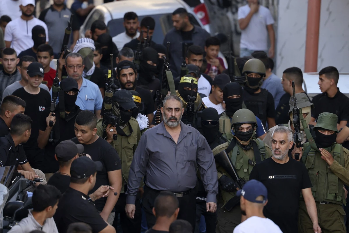 Above, Fathi Zidan Hazem attends the funeral of his son near the West Bank city of Jenin on Sept. 28, 2022. Hazem was shot dead by Israeli forces early Friday, Aug. 21, 2026. (AFP file photo)