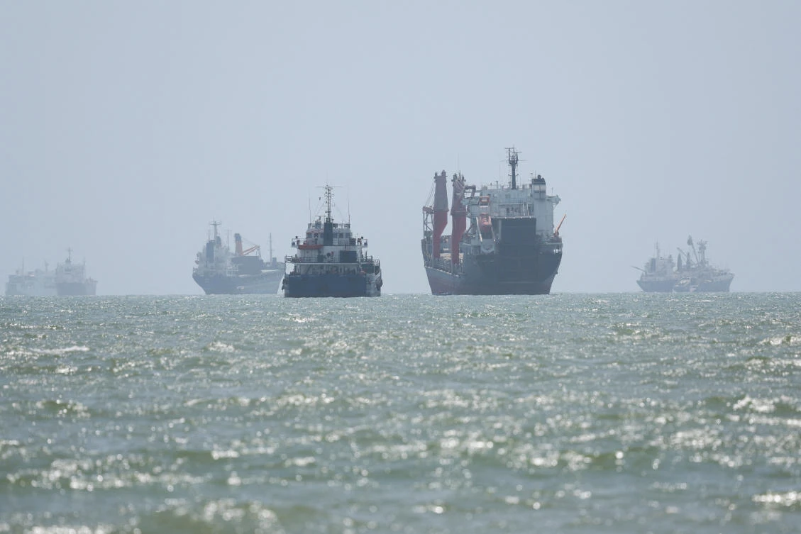 Above, maritime traffic in the Strait of Hormuz are visible near the beach of Bandar Abbas, Iran on Aug. 25, 2026. (WANA via Reuters)