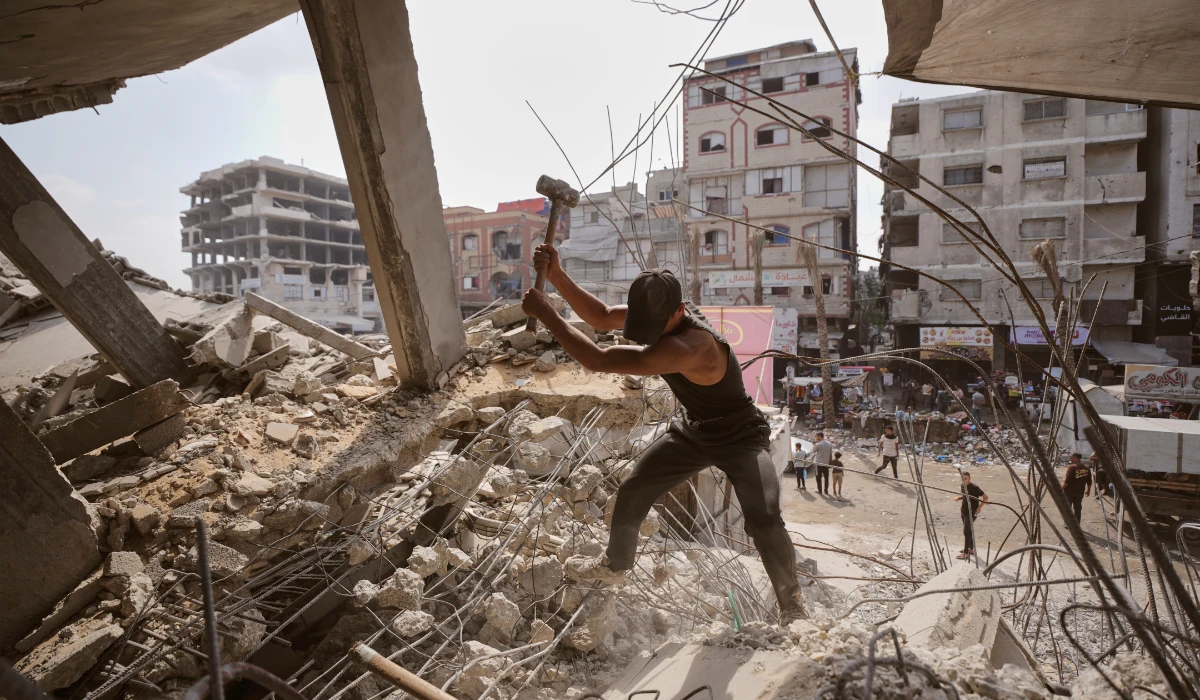Palestinians remove iron from the rubble of buildings destroyed by Israeli airstrikes in Gaza City, Sunday, Aug. 16, 2026. (AP)