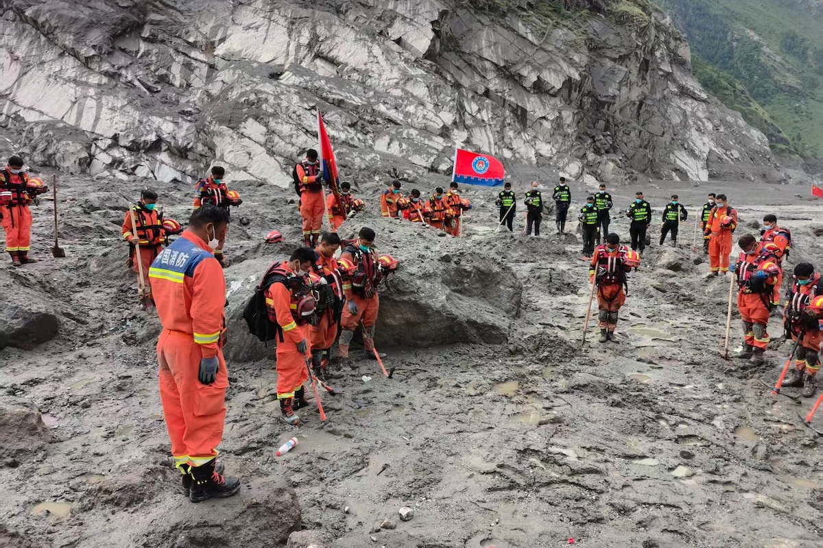 Rescuers observe a moment of silence for the victims of the Aug. 26 mudslide near the Gyirong Port in Gyirong County, southwestern China’s Tibet Autonomous Region on Sept. 1, 2026. (Xinhua via AP)