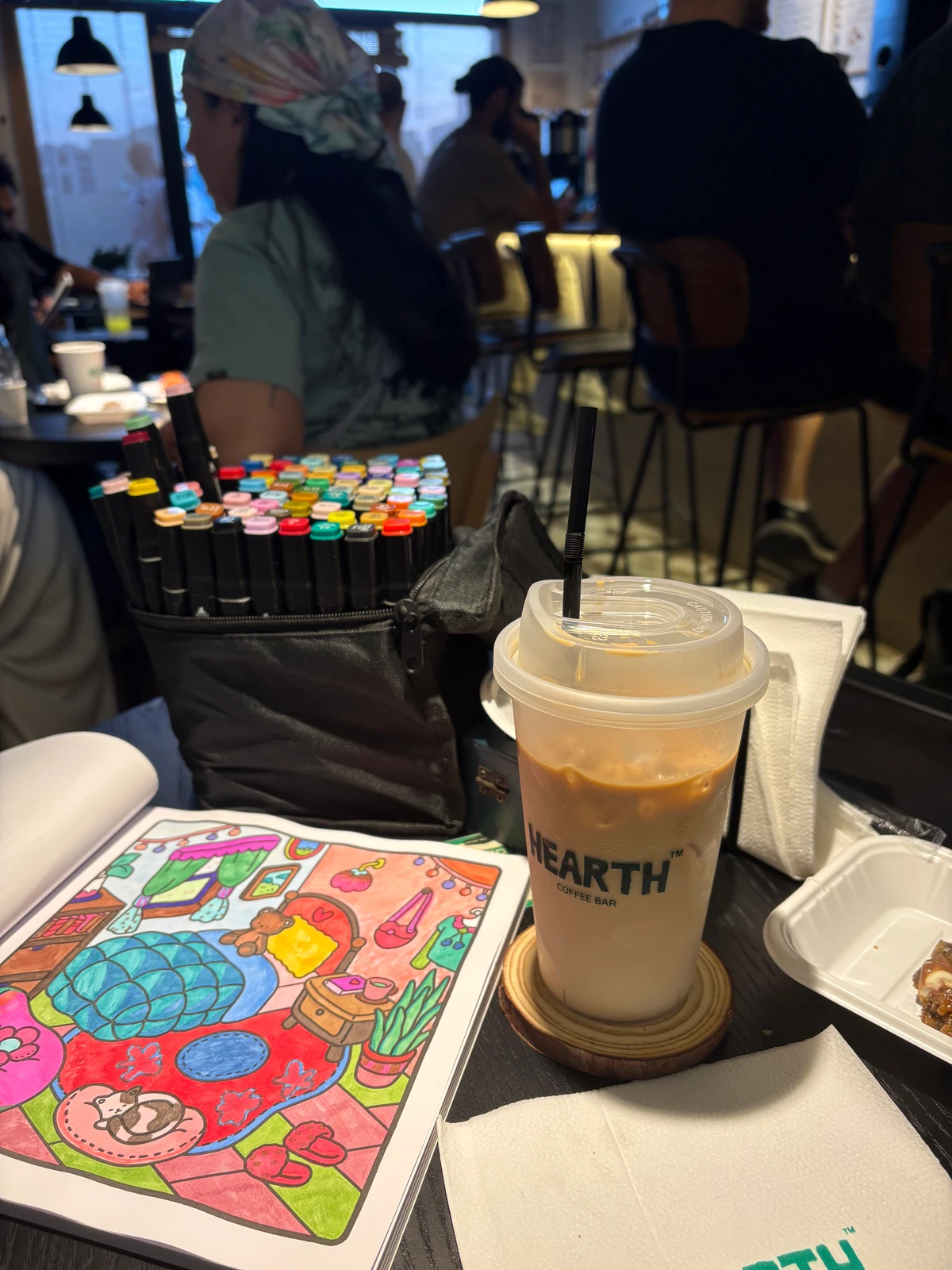 Part coffee and tea bar, part listening cafe, and fully fun, customers are invited to talk, flip through magazines or books together and fill in physical coloring books (AN photo)