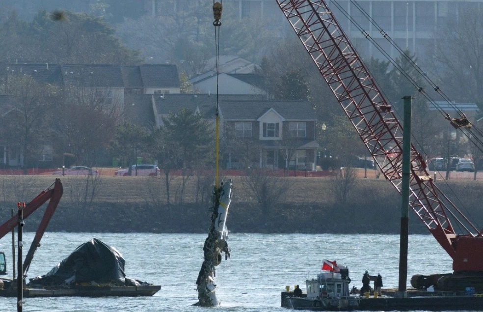 A crane pulls up a portion of the damaged plane during recovery efforts after the American Airlines crash on February 04, 2025 in Arlington, Virginia. (AFP/File)