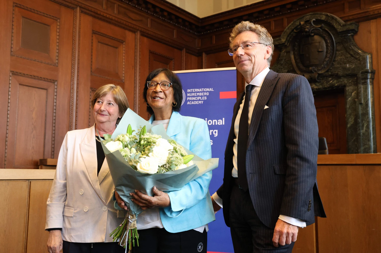 The 2026 Nobel Peace Prize laureate, South African lawyer Navi Pillay poses with the former President of the International Criminal Court (ICC) Silvia Fernandez de Gurmendi (L) and the Director of the International Nuremberg Principles Academy Christoph Safferling (R) at the historic Courtroom 600 of Nuremberg's Palace of Justice (AFP)