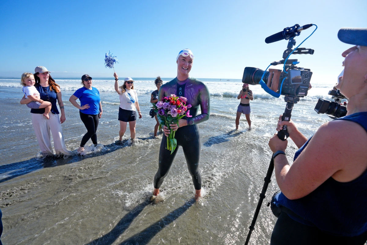 Catherine Breed is celebrated as she reached the beach at Coronado, completing nearly 900 miles swim, Oct. 19, 2026, in Coronado, California. (Nelvin C. Cepeda/The San Diego Union-Tribune via AP)
