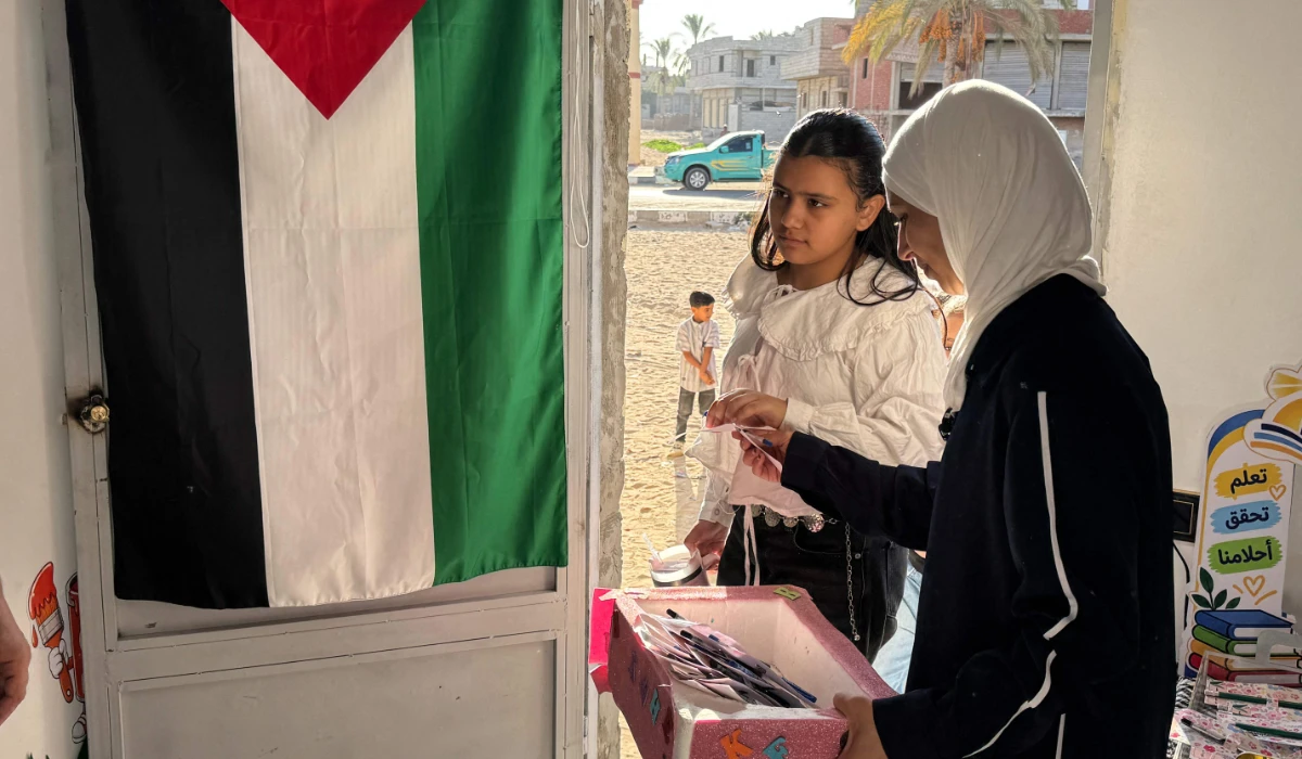 Palestinian teacher Hadeel Zourob stands at the door of a classroom a school for displaced Palestinian children from Gaza, in the Egyptian city of El-Arish, near the border with the Gaza Strip, on October 1, 2026. (AFP)