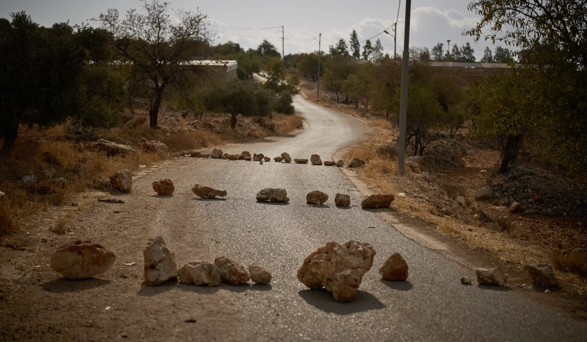 Rocks placed by Palestinians block a road in an effort to prevent Israeli settlers from entering this area of the West Bank village of Burqa, east Ramallah, Friday, Sept. 18, 2026. (AP)