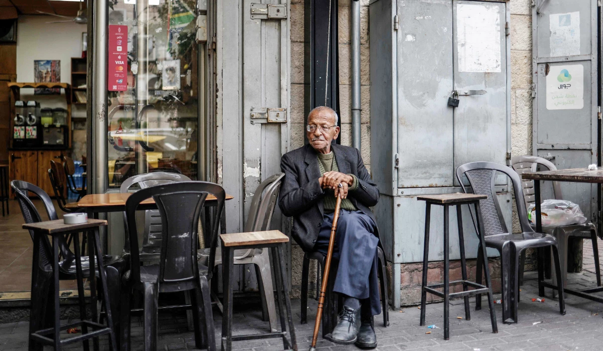 A Palestinian man sits at a coffee shop in Ramallah, in the Israeli-occupied West Bank on October 11, 2026. (AFP)
