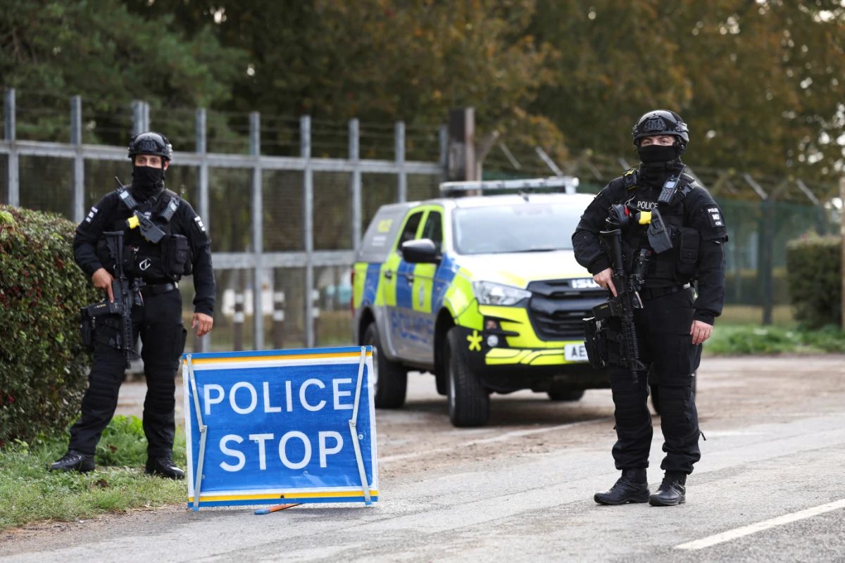Armed police officers stand guard on a road outside the perimeter of the RAF Fairford airbase, on September 28, 2026. (REUTERS)