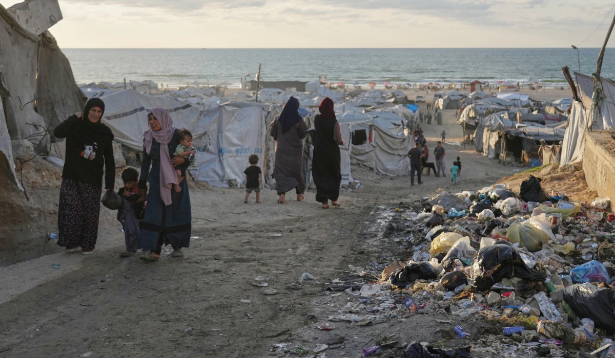 Women walk along a street surrounded by tents sheltering displaced Palestinians, in Gaza City, Saturday, Sept. 26, 2026. (AP)