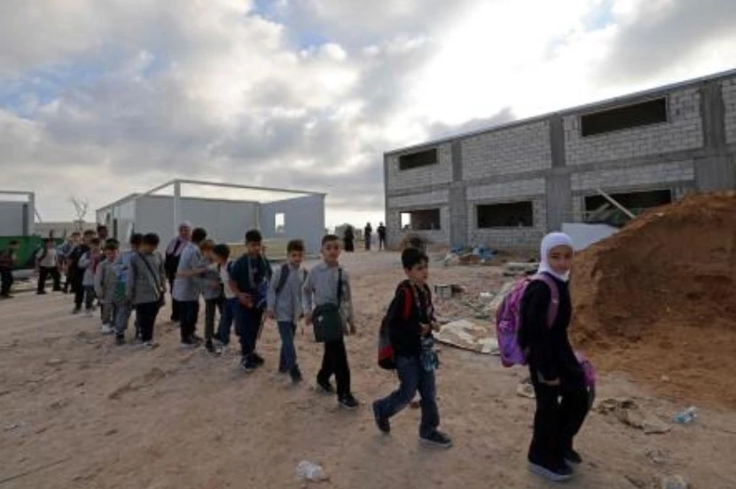 Students arrive to attend their classes in a newly built but unfinished section of Borj Qalaouiyé Intermediate School, whose campus was earlier damaged by Israeli strikes, during the first day of school year at Borj Qalaouiyé in southern Lebanon on Sept. 24, 2026. (AFP)