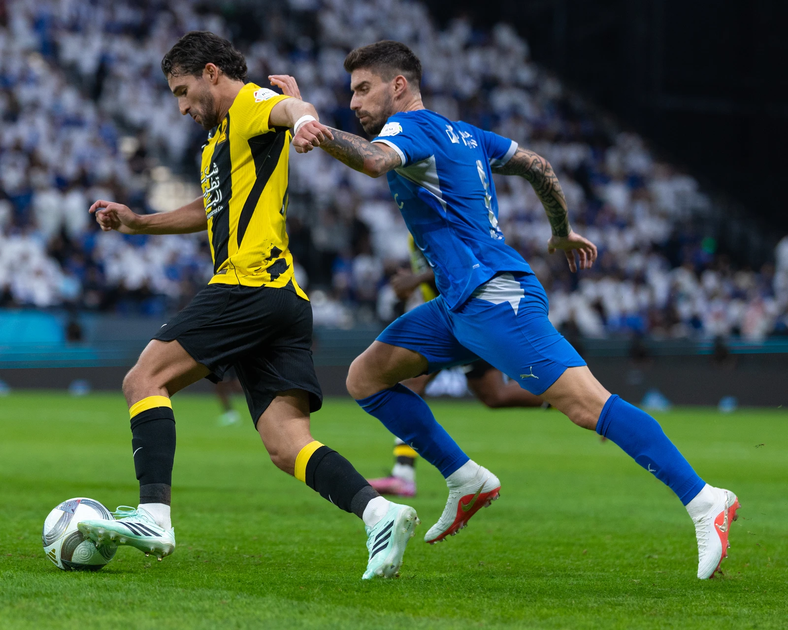 Al-Hilal's Ruben Neves presses Al-Ittihad's Houssem Aouar in midfield. (SPL)