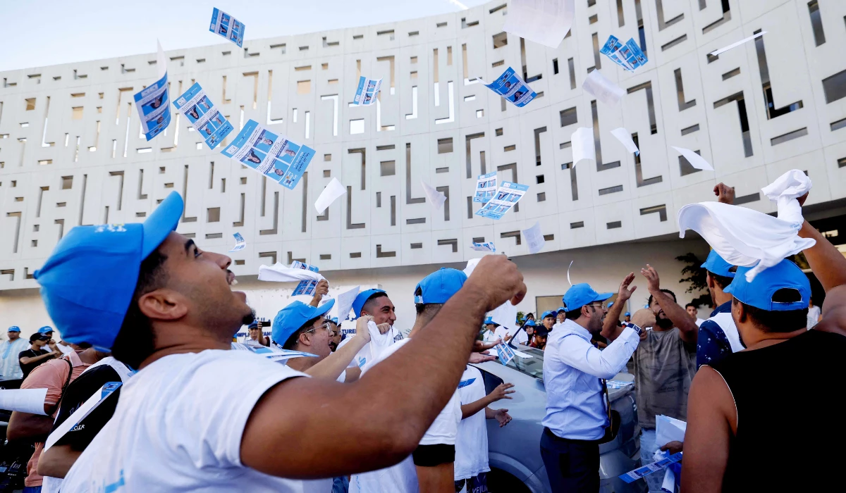 Supporters of the National Rally of Independents (RNI) cheer during a campaign rally in Sale, on September 17, 2026, ahead Moroccoís legislative elections. (AFP)