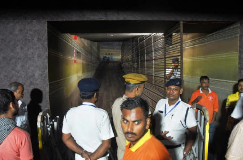 Police officers stand guard at the closed entrance to a worship venue for the Hindu festival of Durga Puja following a stampede, in Kolkata, Oct. 17, 2026. (AP)