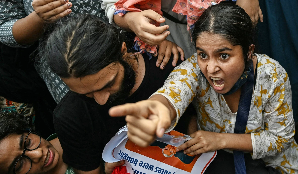 A demonstrator confronts security personnel during a protest demanding the resignation of India's Chief Election Commissioner Gyanesh Kumar over alleged voter roll irregularities linked to the "special intensive revision" (SIR), near Jantar Mantar in New Delhi on October 11, 2026. (AFP)