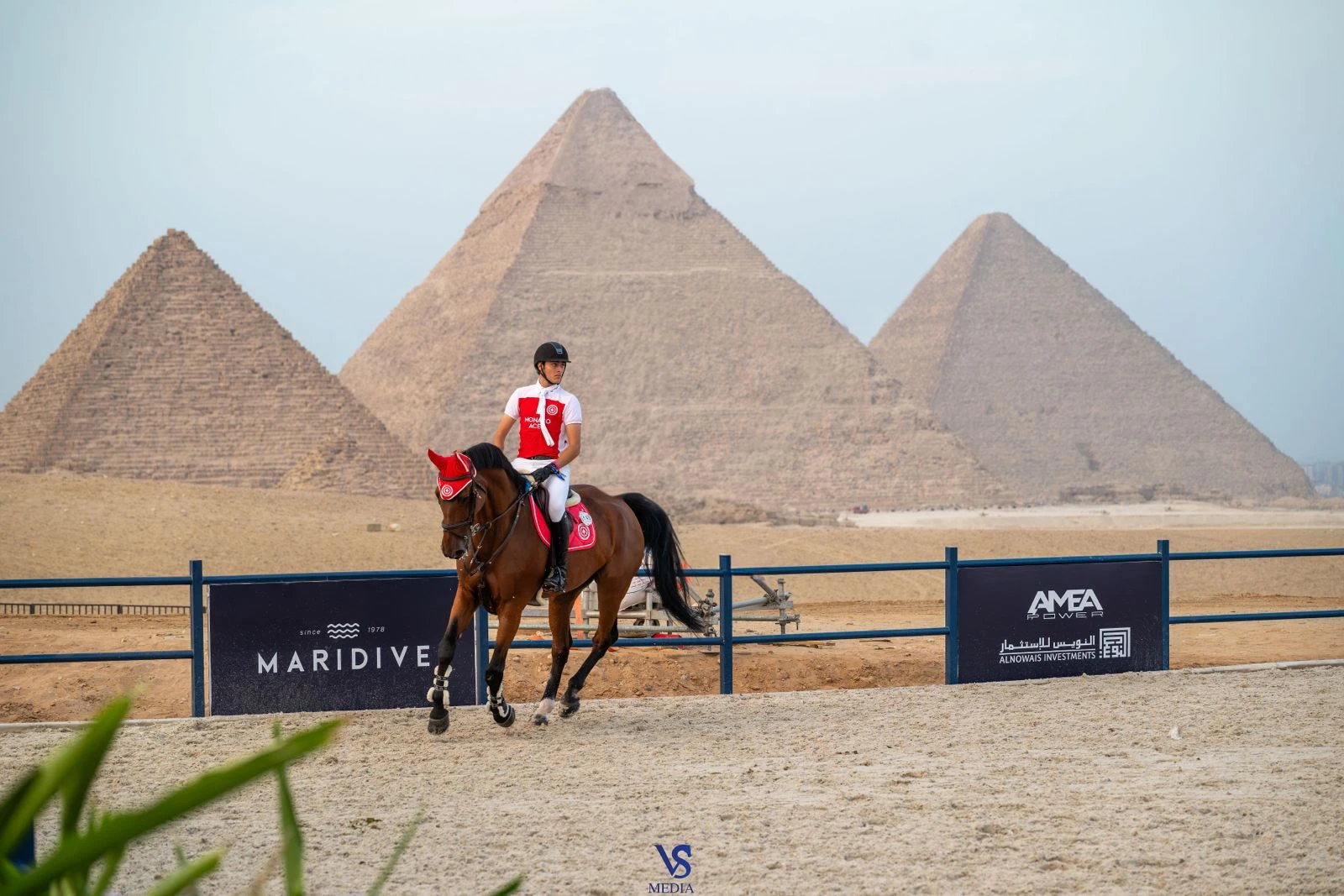 Inigo Lopez De La Osa Franco rides in the Monaco Aces colors at the Longines Global Champions Tour of Cairo, with the Pyramids of Giza behind the arena. (VSMEDIA.EQUESTRIAN)