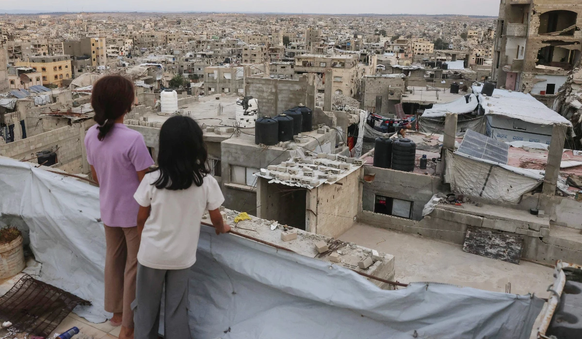 Palestinian children stand on the roof of a building at the Jabalia refugee camp in the northern Gaza Strip on October 5, 2026. (AFP)