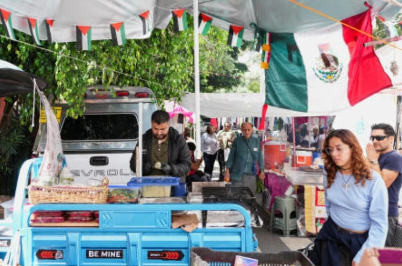 Mohammed Abed, 36, a Palestinian systems engineer who arrived in Mexico in 2025 with 17 family members after losing his daughter in an Israeli airstrike in Gaza, prepares Palestinian food at an open-air market in the Condesa neighborhood of Mexico City, Sept. 22, 2026. (Reuters)