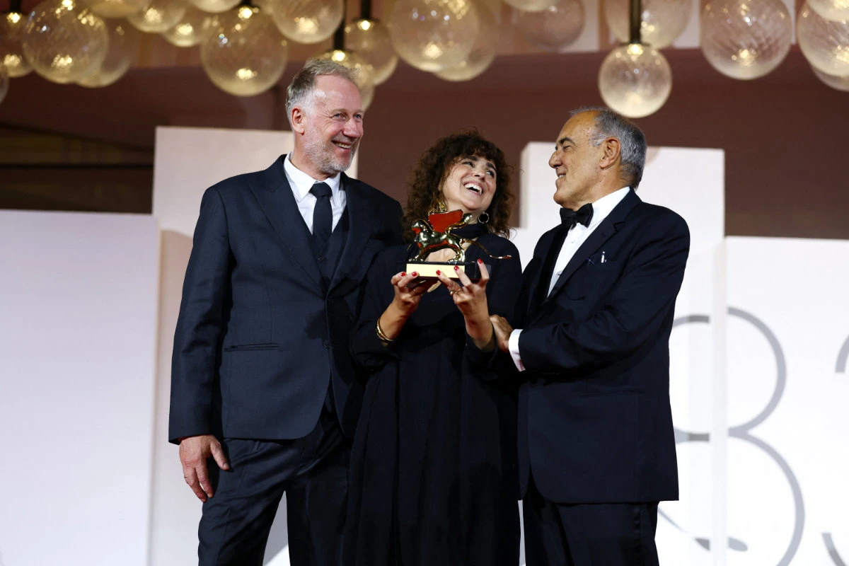 May El-Toukhy, winner of the Golden Lion Award for Best Film for the movie "Woman Unknown", poses with the artistic director of the Venice Film Festival Alberto Barbera, during the closing ceremony of the 83rd Venice International Film Festival on September 12, 2026. (REUTERS/Yves Herman)
