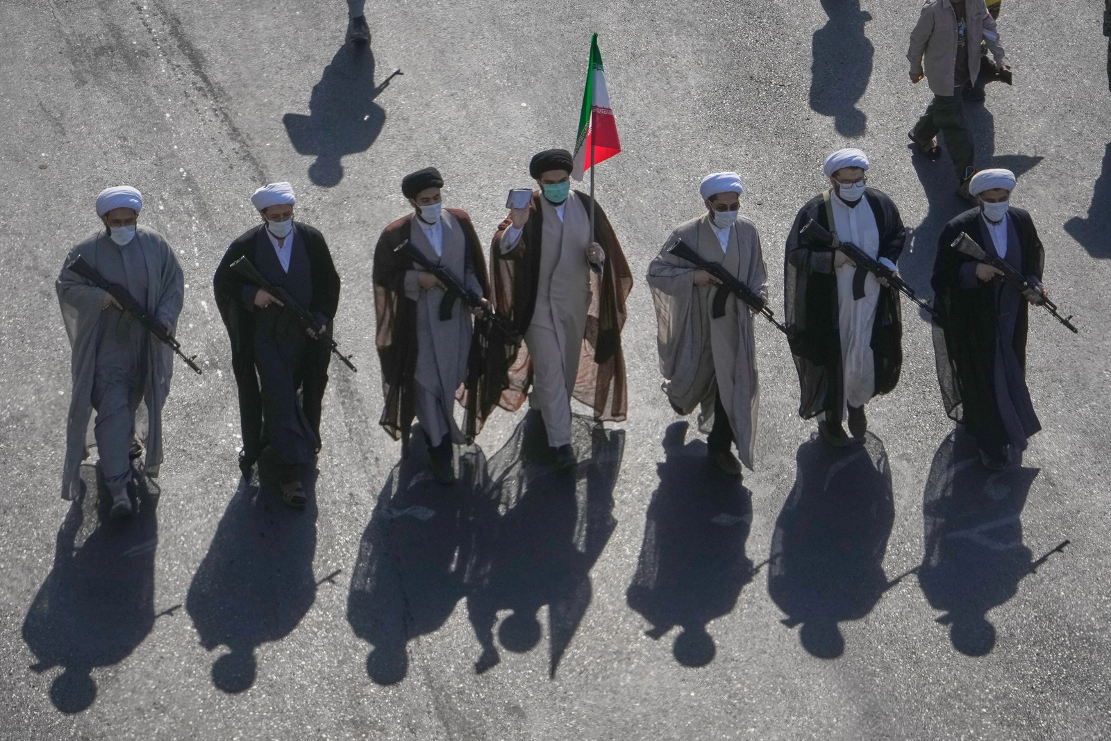 Shiite clerics carrying rifles march during the state-organized "Sacrifice for Iran," military-style parade at Revolution Square in Tehran on Friday. (AP)