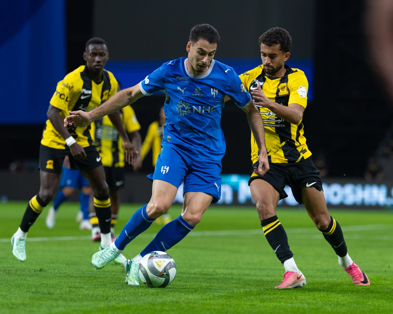 Al-Hilal's Gabriel Martinelli fends off the challenge of Al-Ittihad's Ahmed Al-Ghamdi. (SPL)