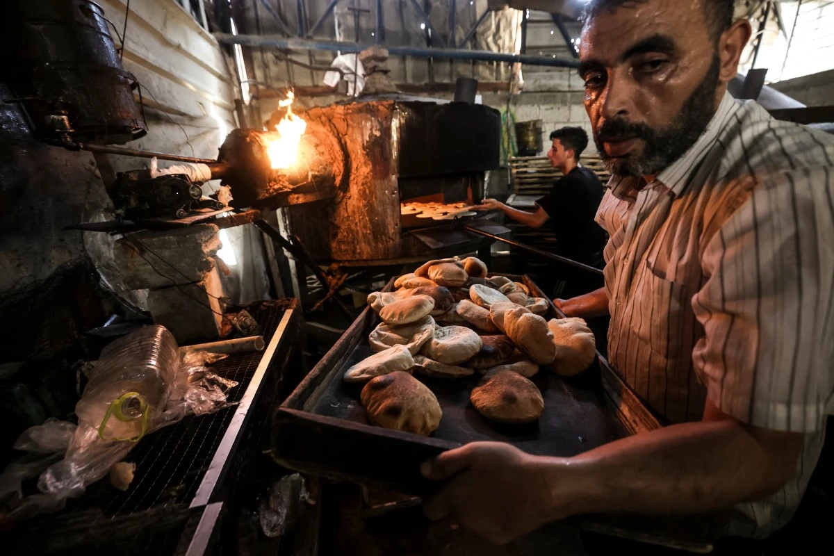 A man bakes bread at a bakery in Al-Bureij in the central Gaza Strip on October 22, 2026.