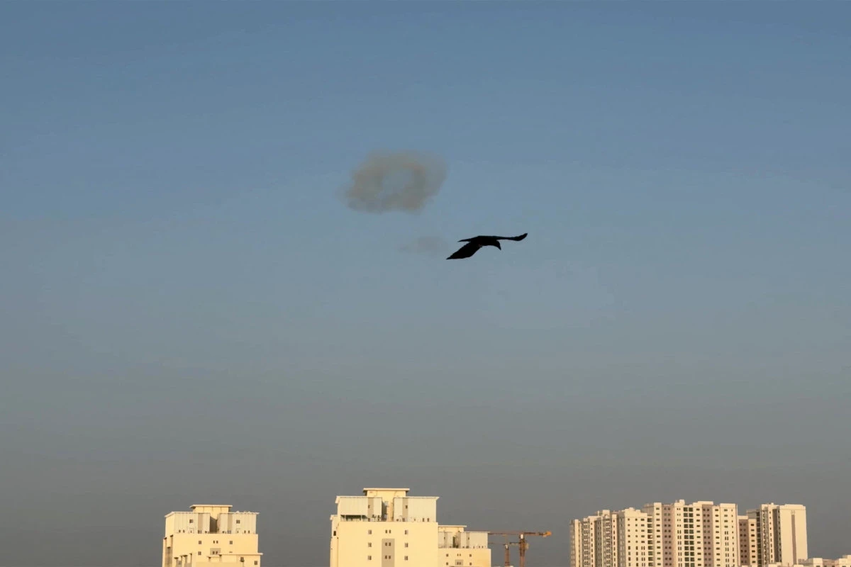 This video grab taken from UGC images posted on social media on September 2, 2026 shows a bird flying as smoke is seen in the sky in northern Bahrain following Iranian drone and missile attacks amid efforts by Bahraini authorities to intercept incoming projectiles. (UAGC/Bahrain)