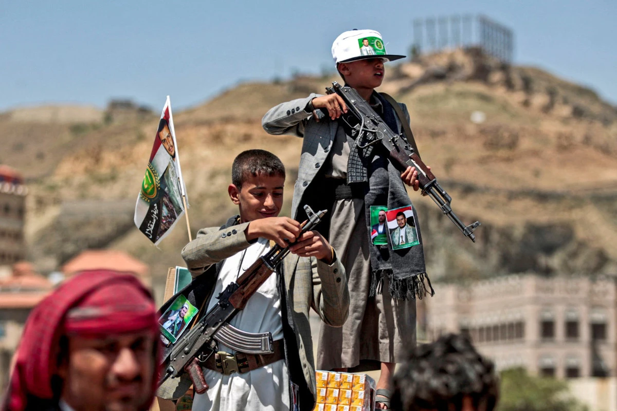 Yemeni boys armed Kalashnikov assault rifles are seen during a tribal meeting in the Houthi militia-held capital Sanaa on September 21, 2019. (AFP/File photo)