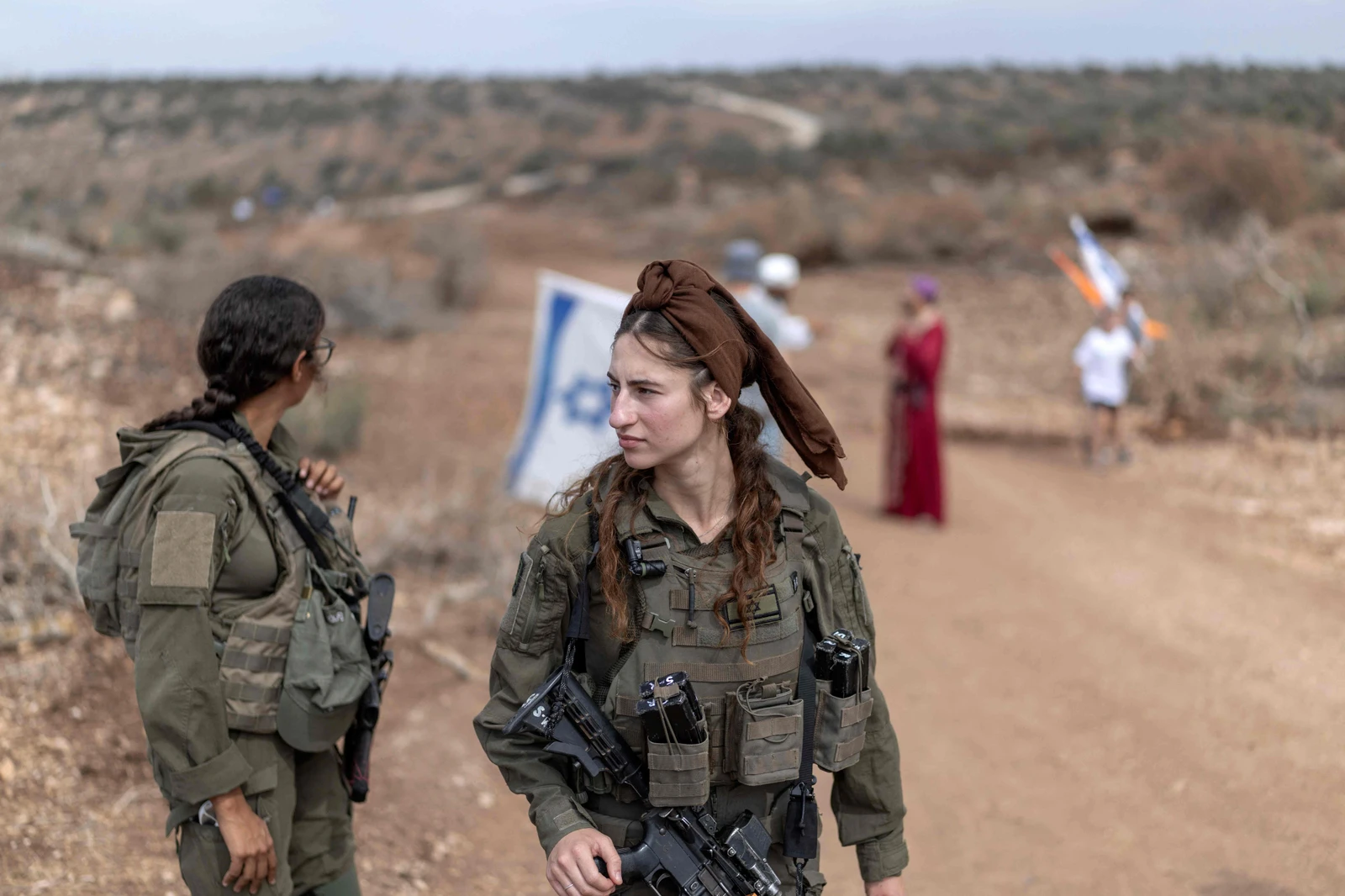 Israeli soldiers are seen guarding the road between Ganim to Kadim settlements as Israelis march through the occupied West Bank. (AFP)