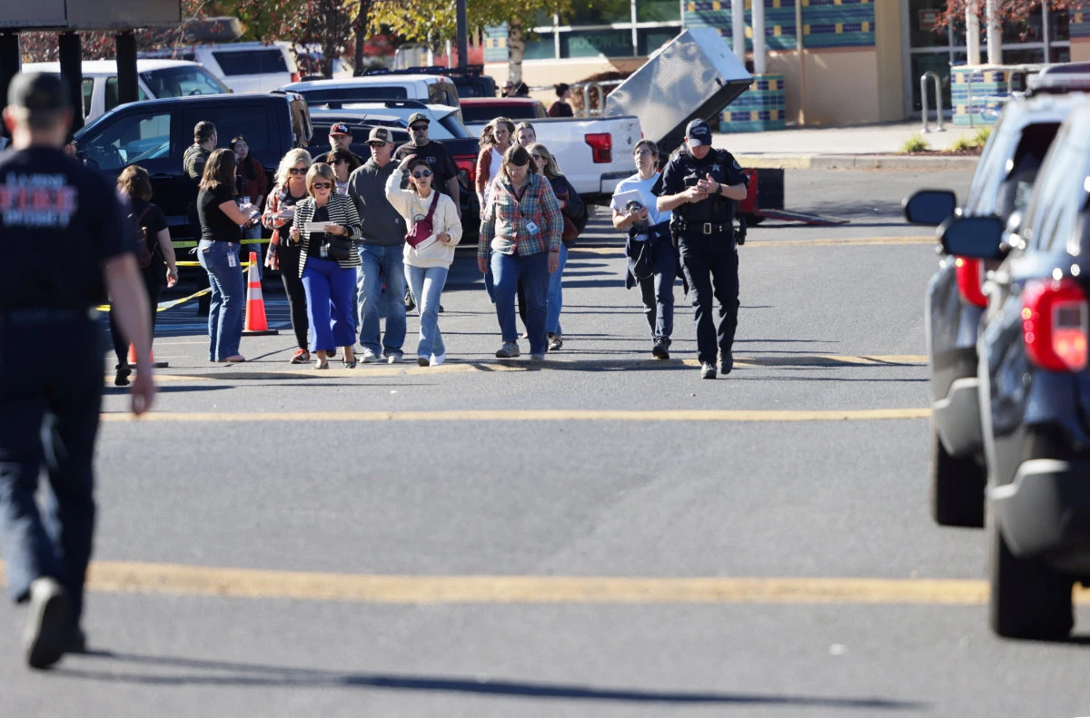 People walk at a family reunification location at Journey Church following a shooting at Silver Rail Elementary School in Bend, Oregon, on October 15, 2026. (REUTERS)