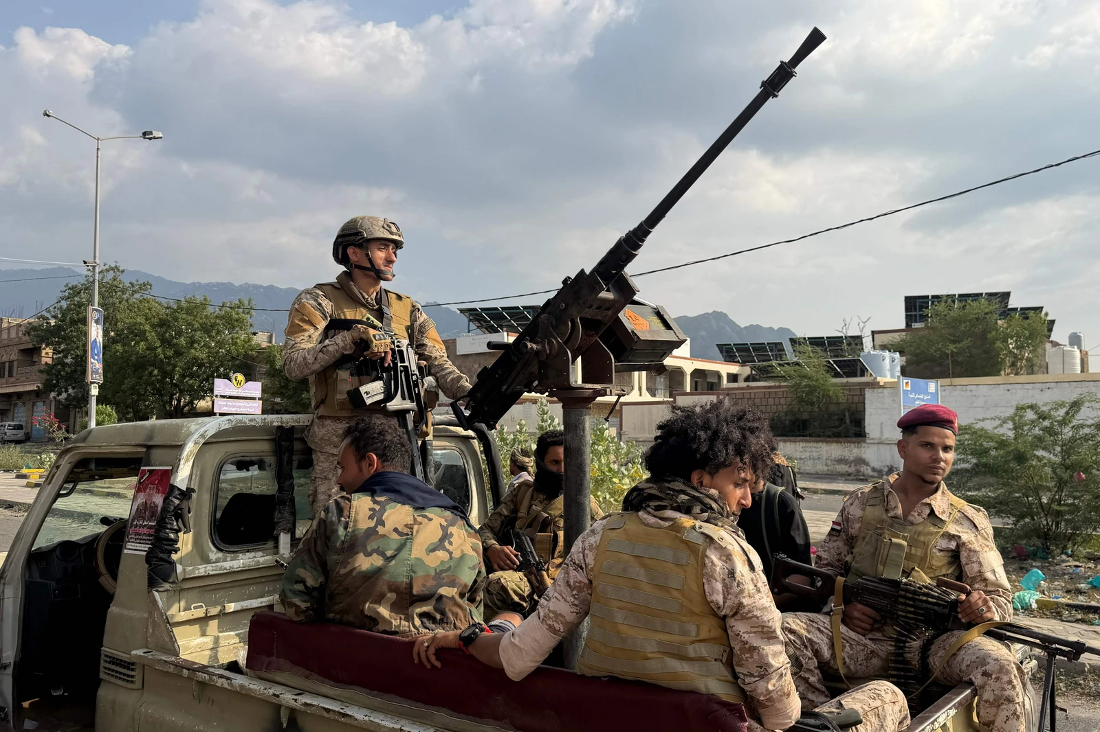 Yemeni government fighters ride on the back of a truck during battles against Yemen's Iran-backed Houthis at the Jabal Han front west of the city of Taiz on Wednesday. (AFP)