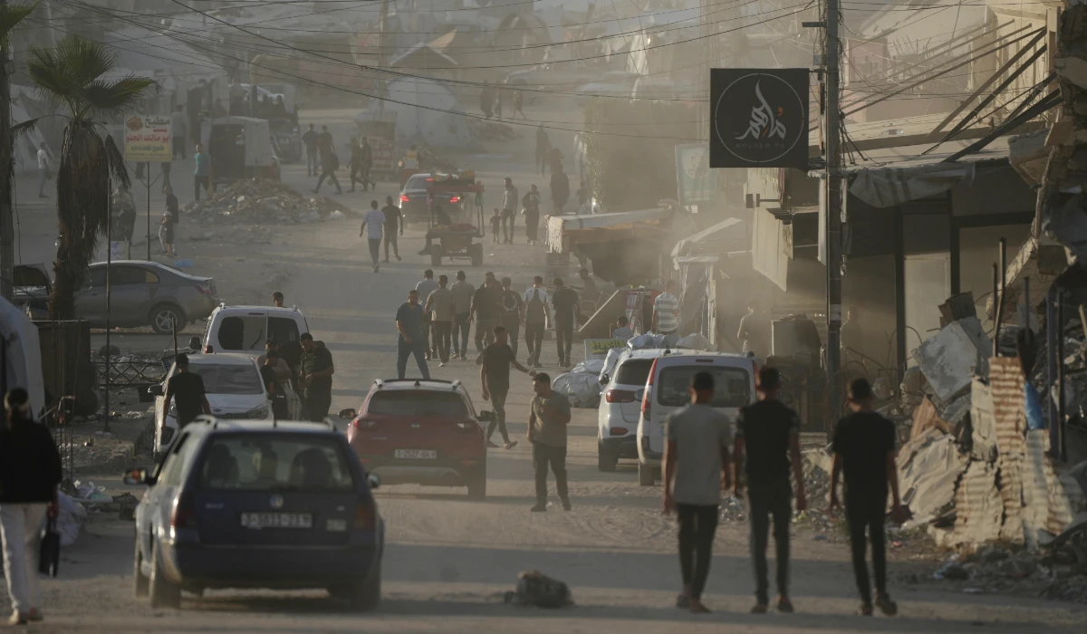 Palestinians walk along a street surrounded by war-damaged buildings in Gaza City, Saturday, Sept. 26, 2026. (AP)
