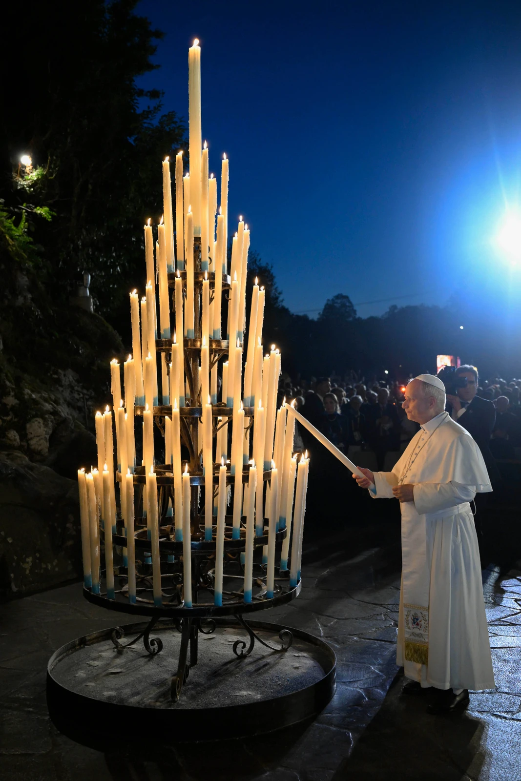 Pope Leo lights candles before praying at the Grotto of the Apparitions of Massabielle, in Lourdes, France, on Sept. 26, 2026. (Vatican Media via AP)